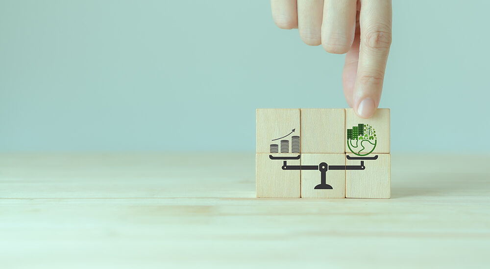 Sustainable development concept. Weight scale with green planet and money growth. Green business culture, environmental sustainability policy. ESG, sustainable business, positive impact on the world.