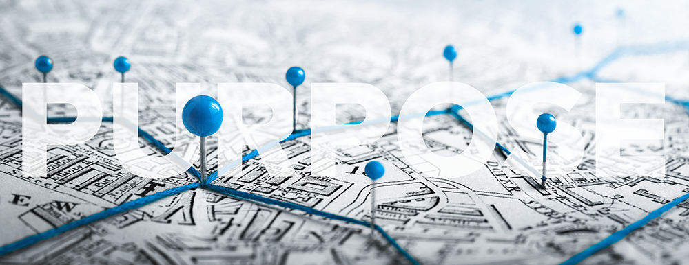 A map with blue pins and string, with the word 